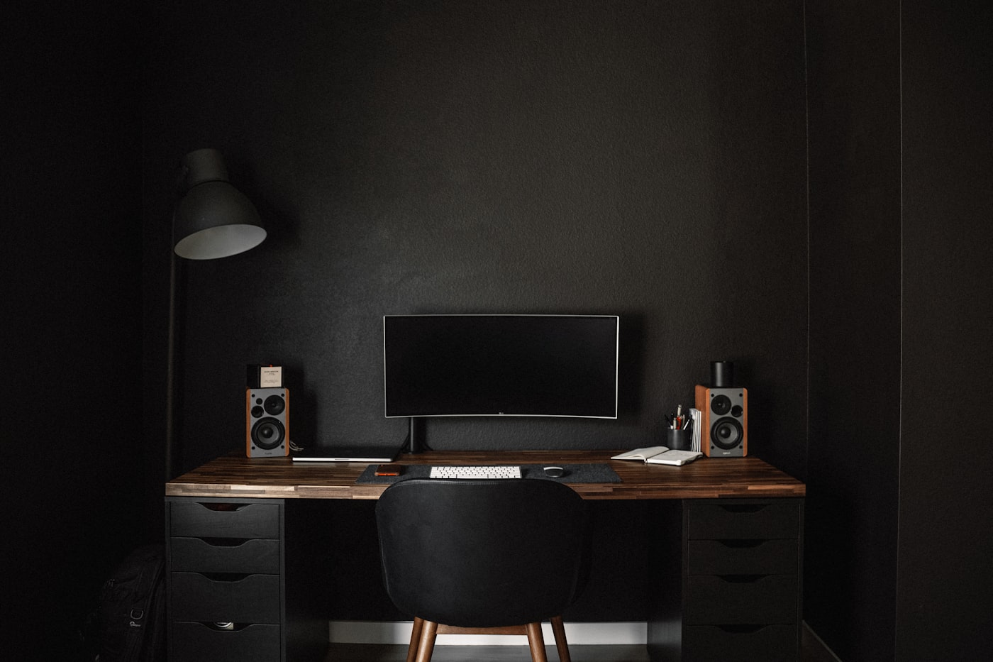 A minimalist dark home-office desk setup