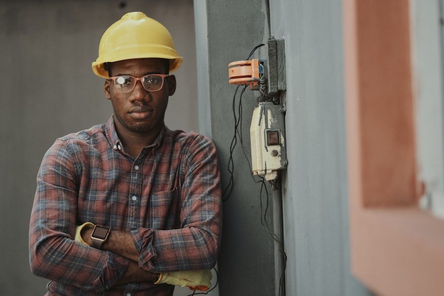 Electrician in a hard hat and safety glasses